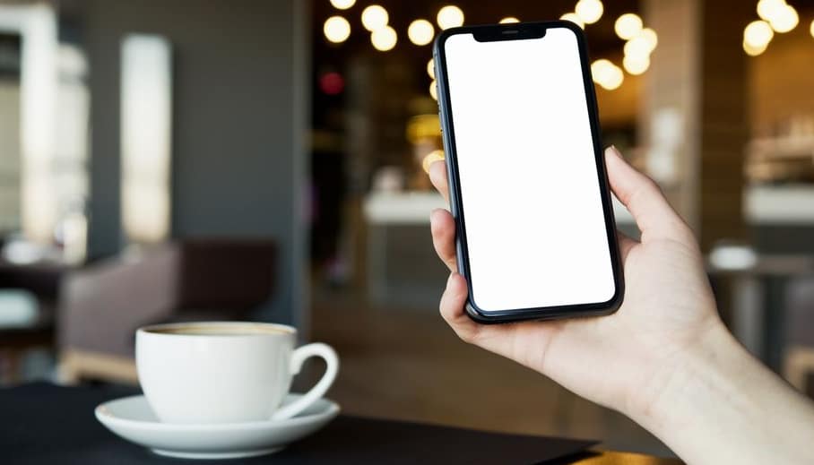 Owner of a neighbourhood bakery checking daily takings on a phone