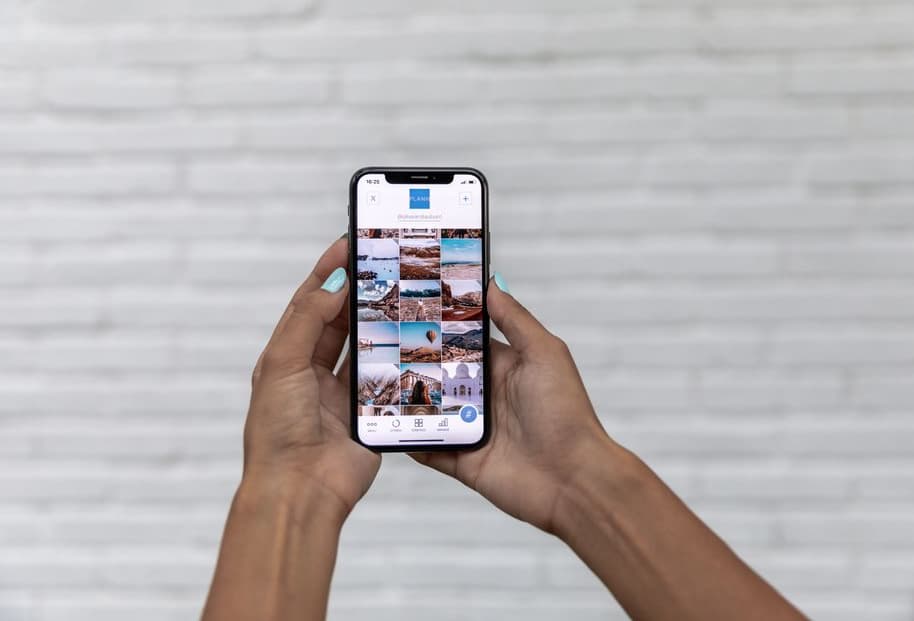 Electrician photographing a receipt with a phone beside a van